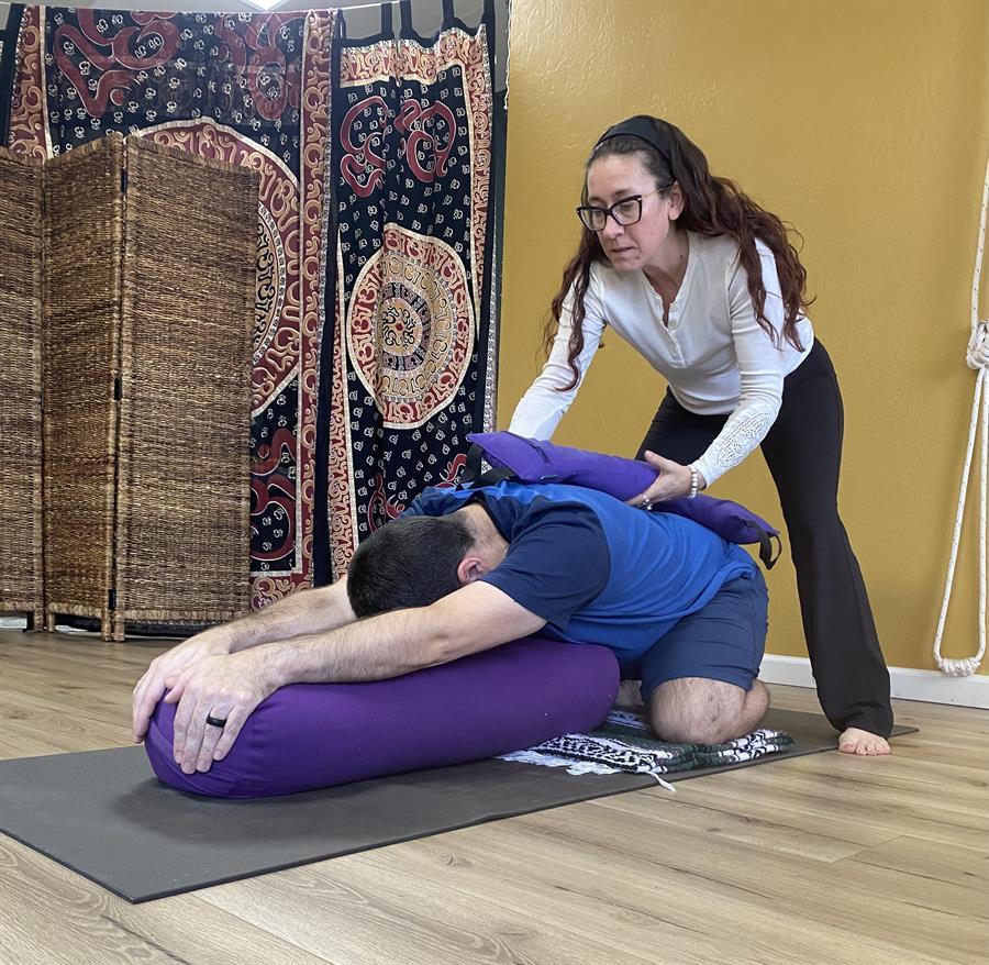 Man supported in Restorative Childs Pose